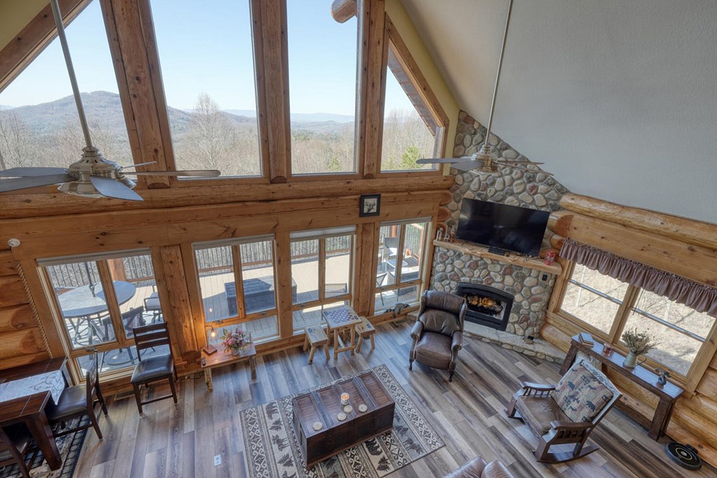 103 Wisteria Drive Murphy, NC 28906 - Photo 24 of 62 a living room with furniture a fireplace and a floor to ceiling window
