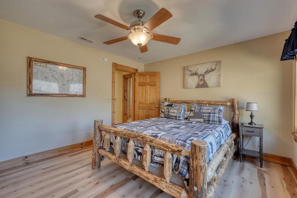 103 Wisteria Drive Murphy, NC 28906 - Photo 26 of 62 a bedroom with a bed a dresser and wooden floor