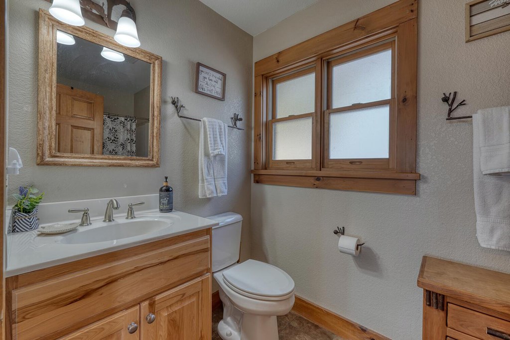 103 Wisteria Drive Murphy, NC 28906 - Photo 28 of 62 a bathroom with a granite countertop toilet sink and mirror