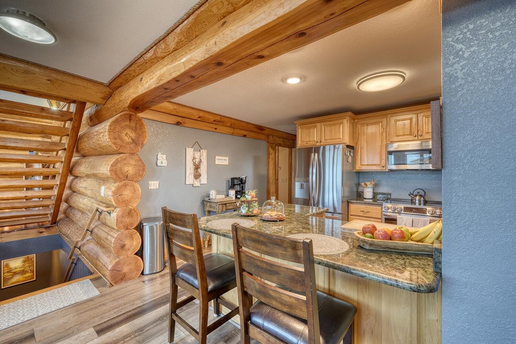 103 Wisteria Drive Murphy, NC 28906 - Photo 31 of 62 a dining room with granite countertop furniture and a fireplace
