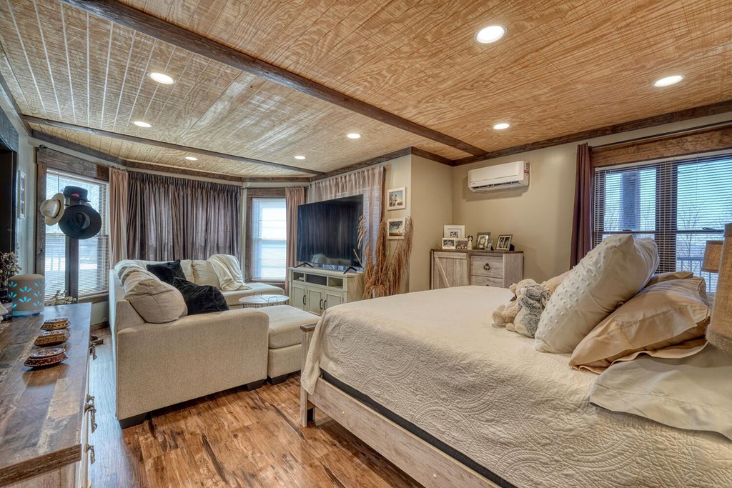 103 Wisteria Drive Murphy, NC 28906 - Photo 36 of 62 a spacious bedroom with a bed and a couch