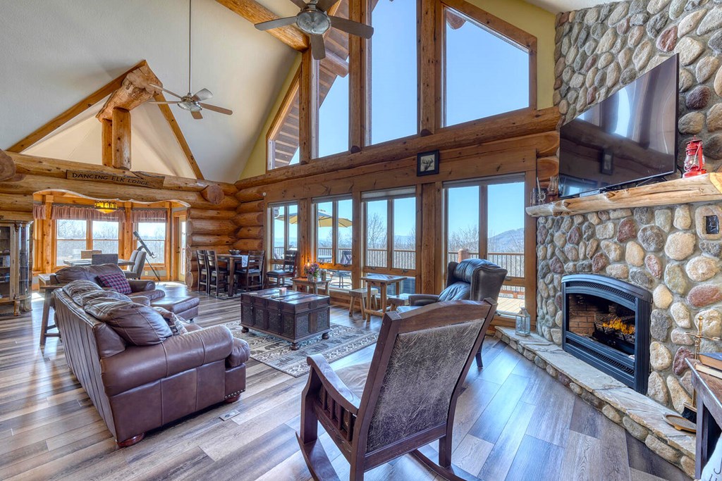 103 Wisteria Drive Murphy, NC 28906 - Photo 9 of 62 a living room with furniture a fireplace and a floor to ceiling window