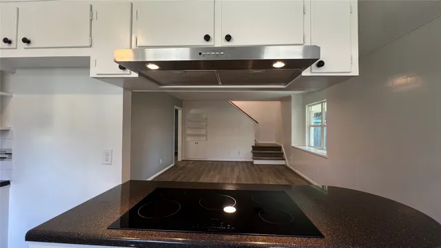 a view of a kitchen cabinets and wooden floor
