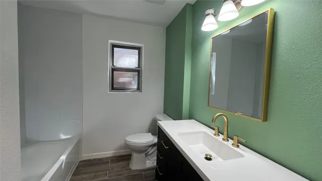 a bathroom with a toilet a sink and a bathtub
