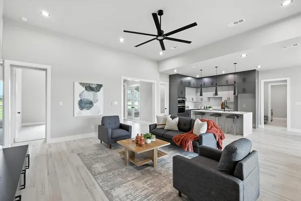 a living room with furniture and kitchen view
