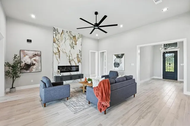 a living room with furniture and wooden floor