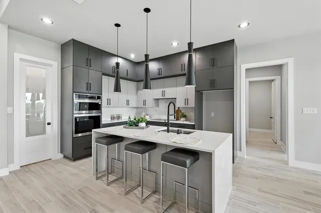 a kitchen with stainless steel appliances kitchen island a island in the center and wooden floors
