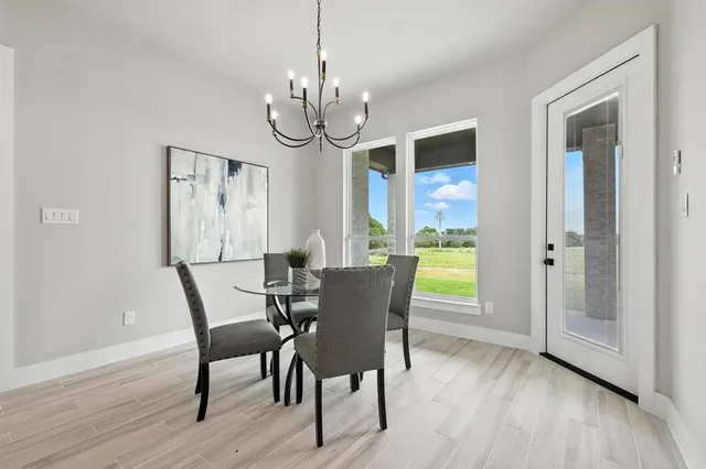 a view of a dining room with furniture wooden floor and chandelier
