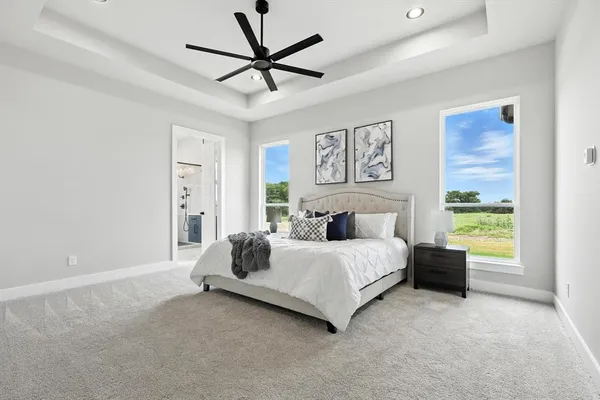 a spacious bedroom with a bed and a window