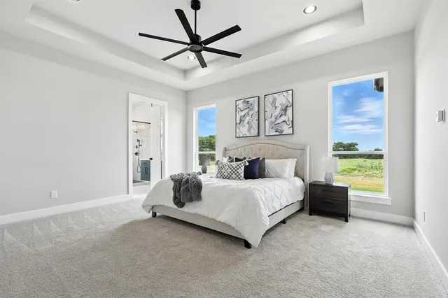 a spacious bedroom with a bed and a window