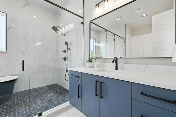 a bathroom with a sink double vanity and mirror