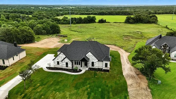 an aerial view of a house with big yard