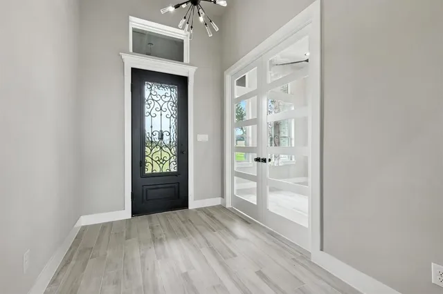 a view of an entryway with wooden floor
