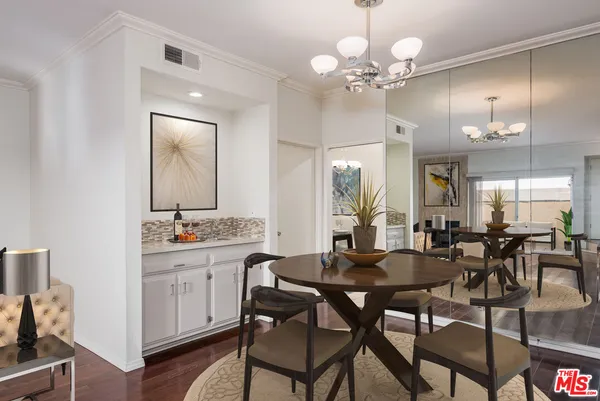 a view of a dining room with furniture and a chandelier fan