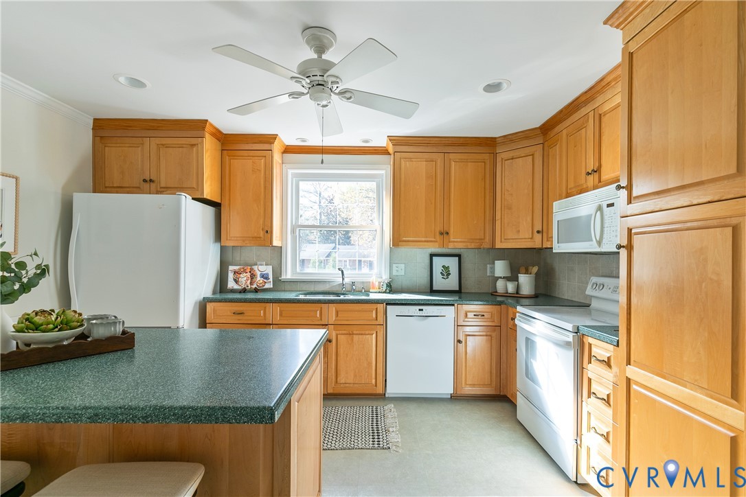 10200 Merrigan Road Richmond, VA 23235 - Photo 19 of 47 a kitchen with stainless steel appliances granite countertop a sink a stove and refrigerator