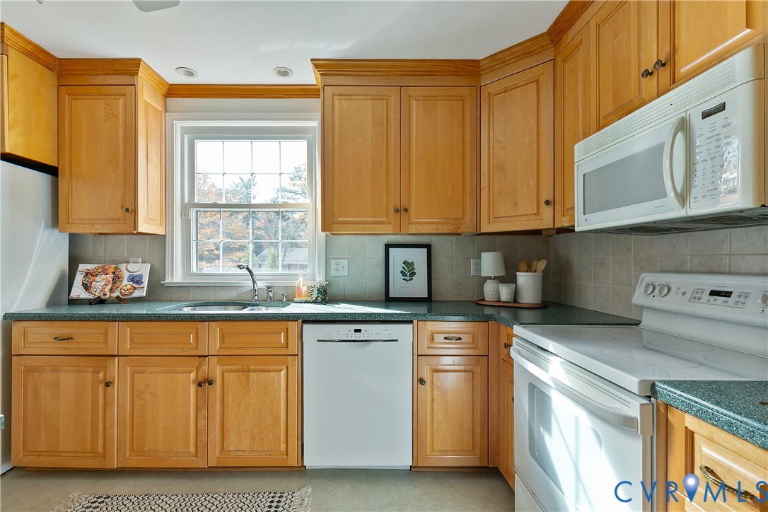 10200 Merrigan Road Richmond, VA 23235 - Photo 20 of 47 a kitchen with cabinets appliances a sink and a window