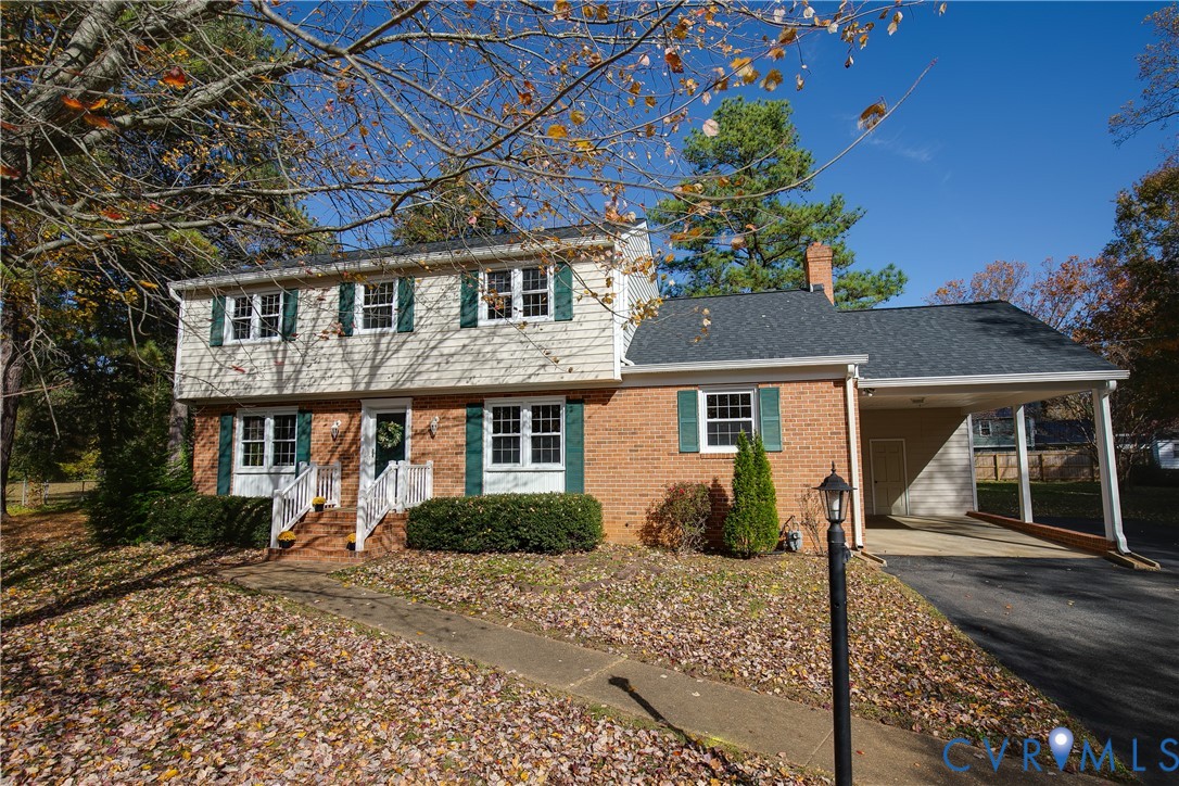 10200 Merrigan Road Richmond, VA 23235 - Photo 2 of 47 a front view of a house with garden
