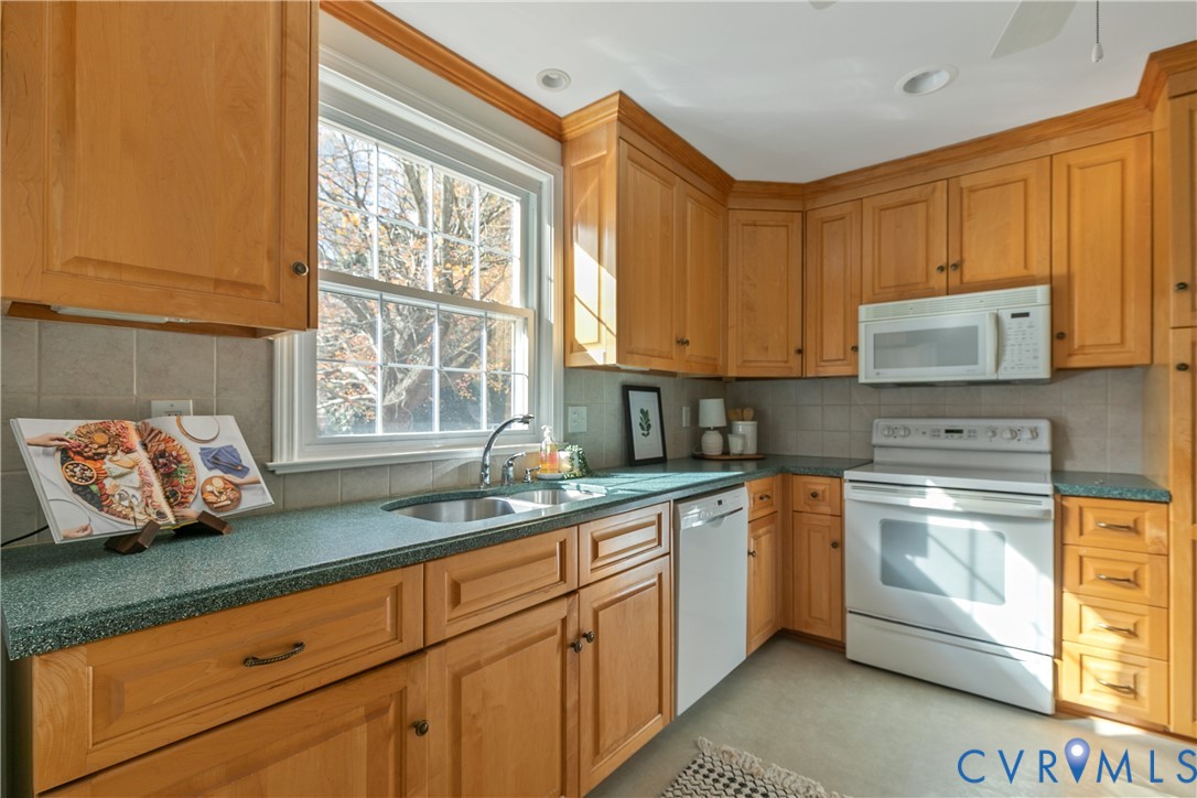 10200 Merrigan Road Richmond, VA 23235 - Photo 21 of 47 a kitchen with stainless steel appliances granite countertop a sink window and cabinets