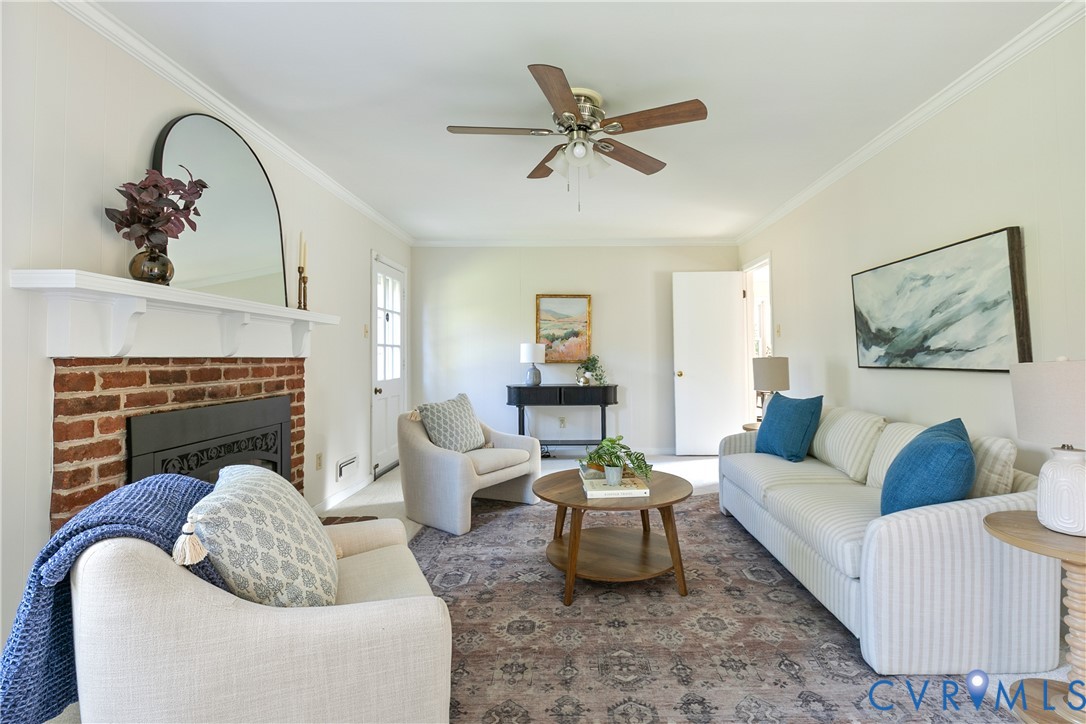10200 Merrigan Road Richmond, VA 23235 - Photo 24 of 47 a living room with furniture and a fireplace