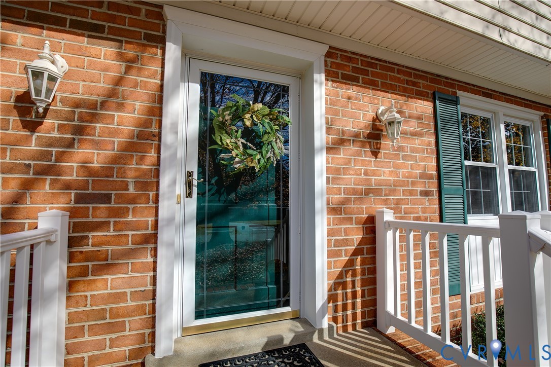 10200 Merrigan Road Richmond, VA 23235 - Photo 8 of 47 a view of a balcony with a door and wooden floor