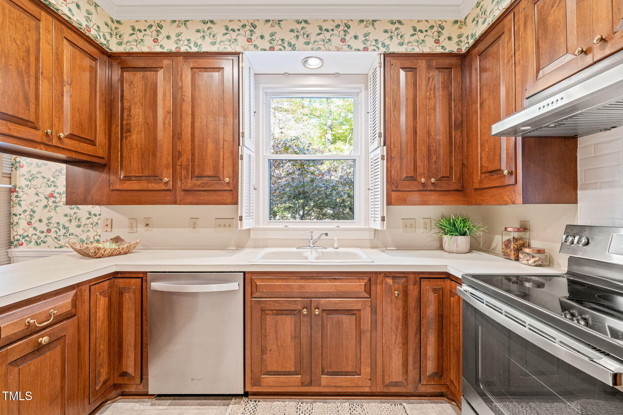 2209 Ridgefield Drive Chapel Hill, NC 27517 - Photo 14 of 57 a kitchen with stainless steel appliances granite countertop a sink a stove cabinets and a window