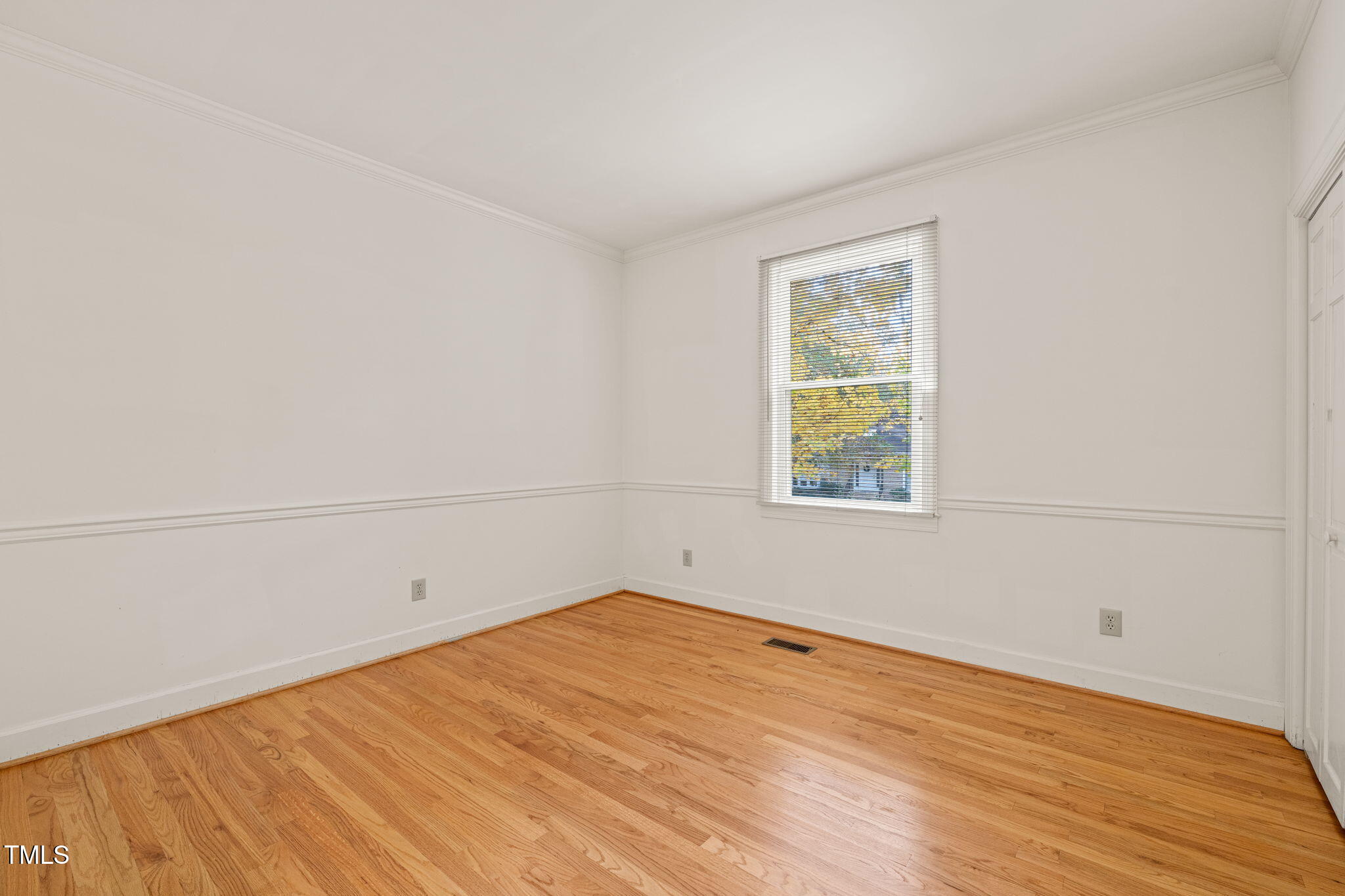 2209 Ridgefield Drive Chapel Hill, NC 27517 - Photo 30 of 57 an empty room with wooden floor and windows