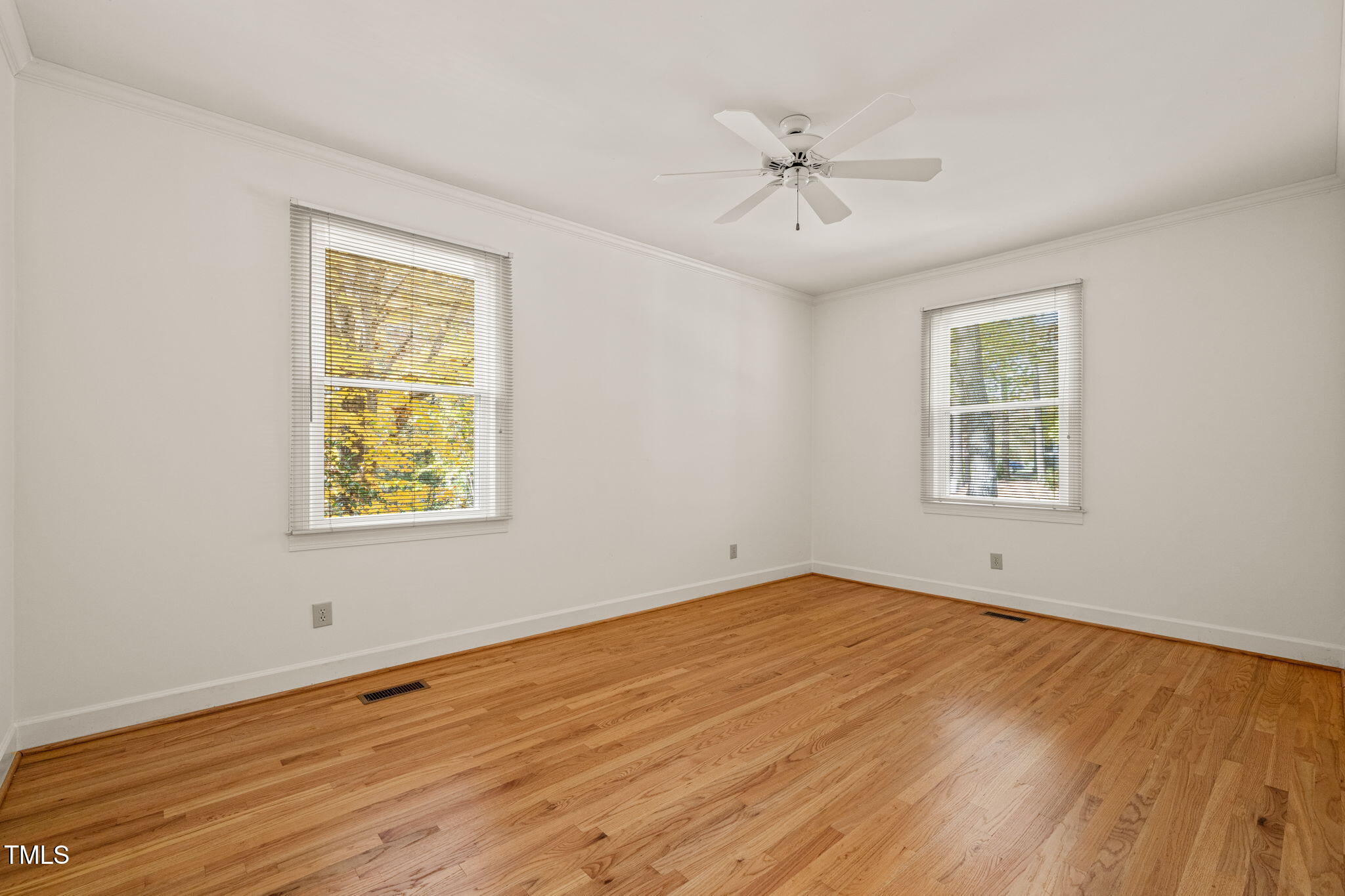 2209 Ridgefield Drive Chapel Hill, NC 27517 - Photo 33 of 57 a view of an empty room with a window and wooden floor