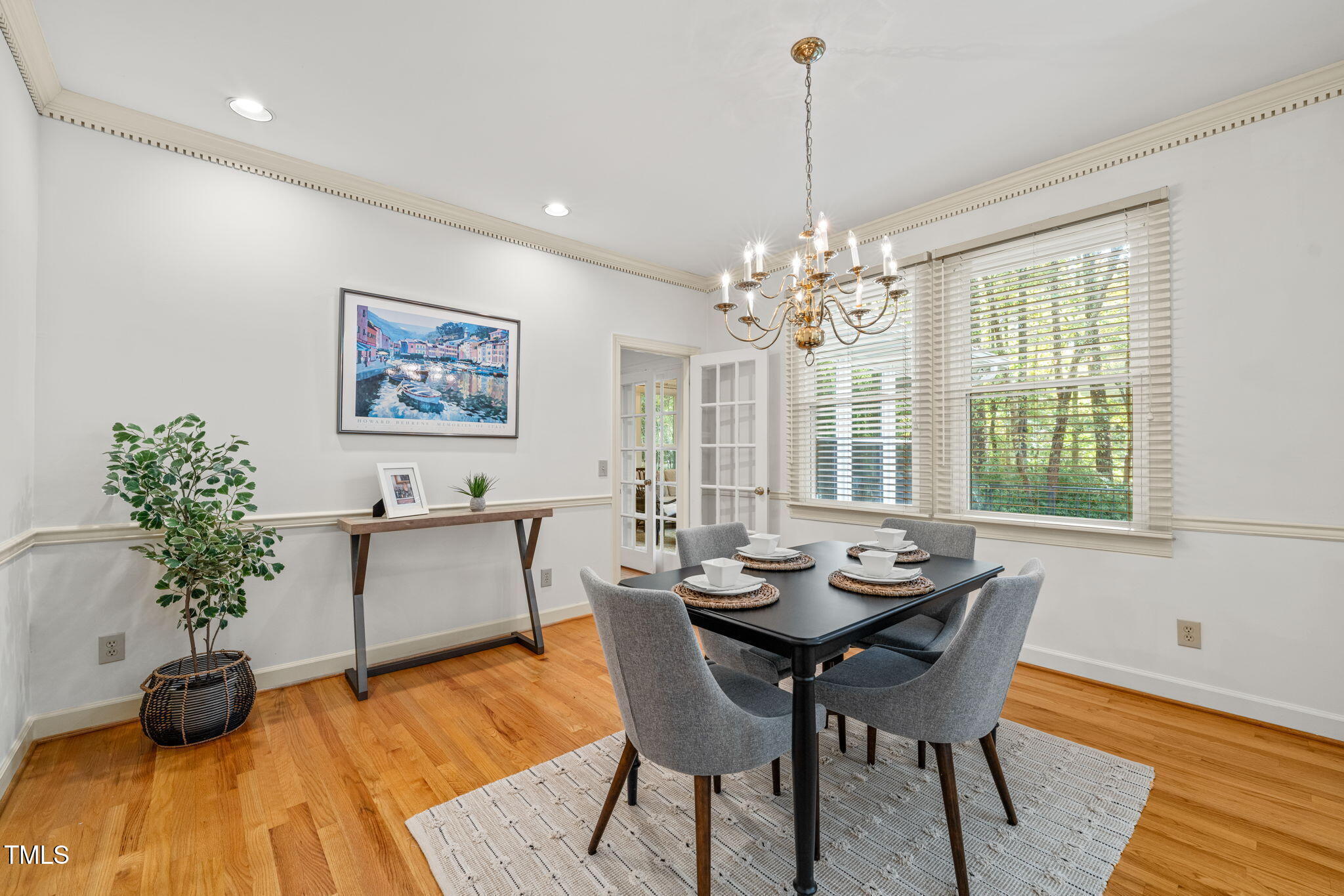 2209 Ridgefield Drive Chapel Hill, NC 27517 - Photo 8 of 57 a dining room with furniture potted plants and wooden floor