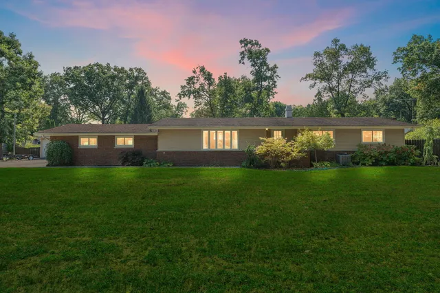 a view of house with a yard