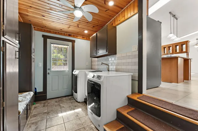 a view of kitchen with sink and refrigerator