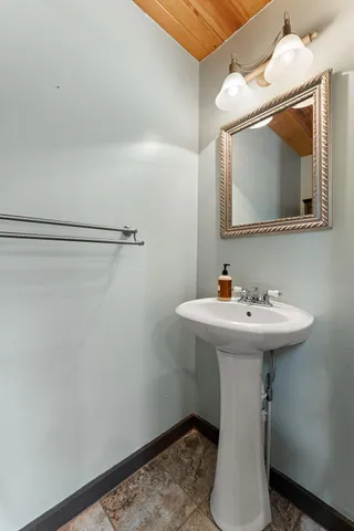 a bathroom with a sink toilet and mirror