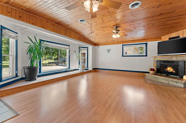 a view of empty room with wooden floor and fireplace