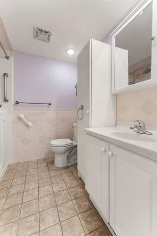 a bathroom with a sink a toilet and a mirror