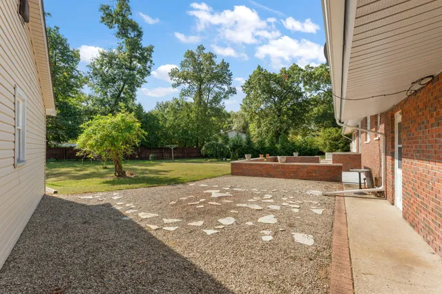 a view of a swimming pool with a yard