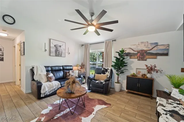 a living room with furniture and a chandelier