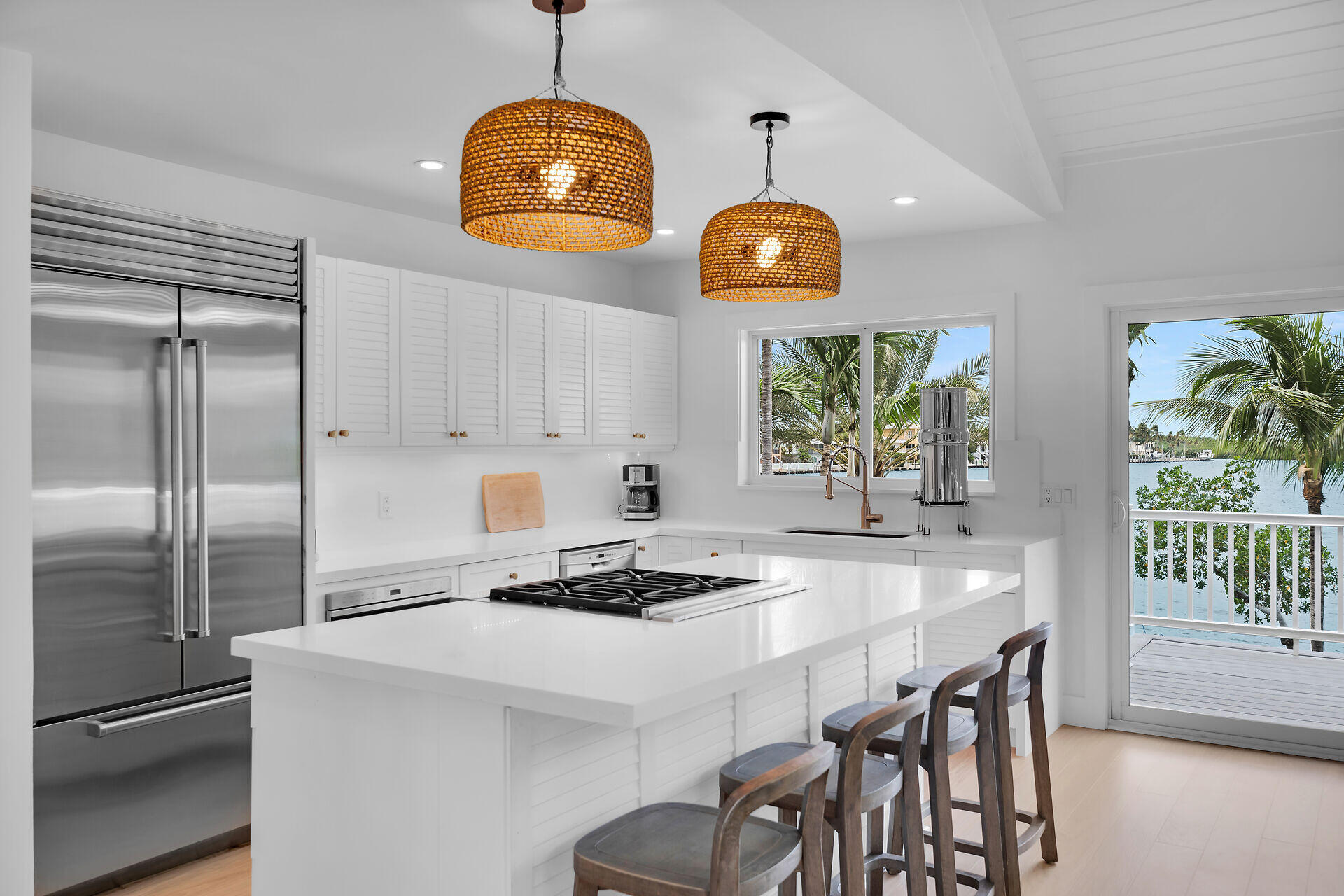 116 Gulf Side Drive Islamorada, FL 33036 - Photo 28 of 67 a kitchen with stainless steel appliances granite countertop a stove a refrigerator a oven a sink a dining table and chairs with wooden floor