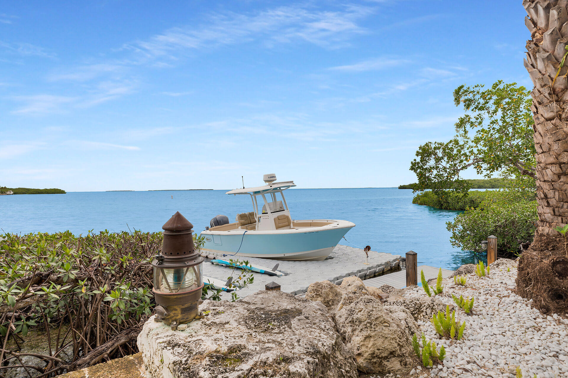 116 Gulf Side Drive Islamorada, FL 33036 - Photo 61 of 67 a view of a balcony with two chairs and a potted plant
