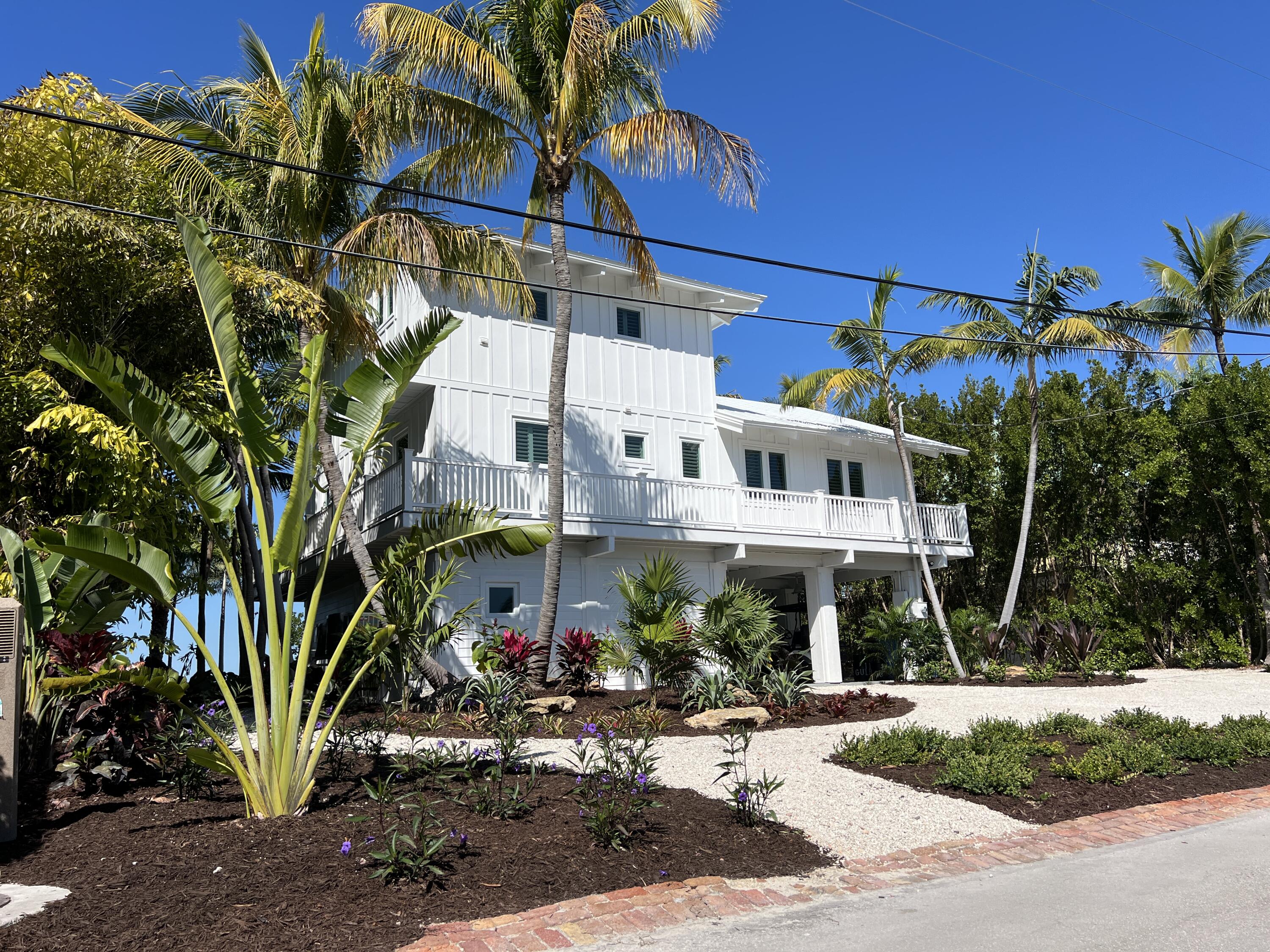 116 Gulf Side Drive Islamorada, FL 33036 - Photo 65 of 67 a view of a building with a tree in front