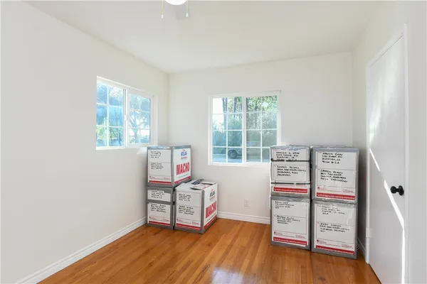 an empty room with furniture and wooden floor