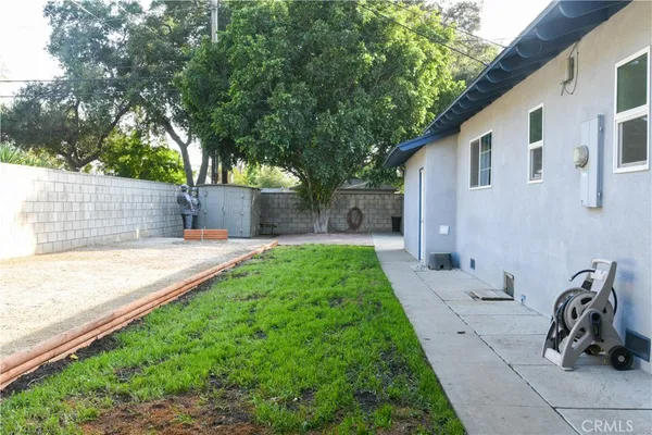 a backyard of a house with table and chairs