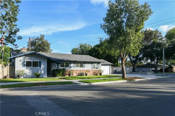 an aerial view of a house with a yard and potted plants