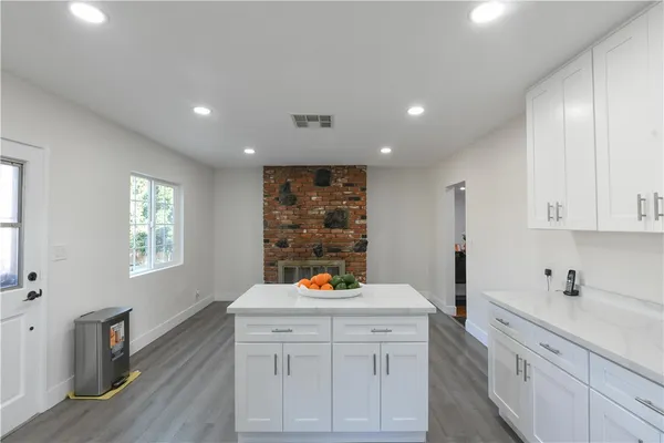 a very nice looking room with a large window and wooden floors