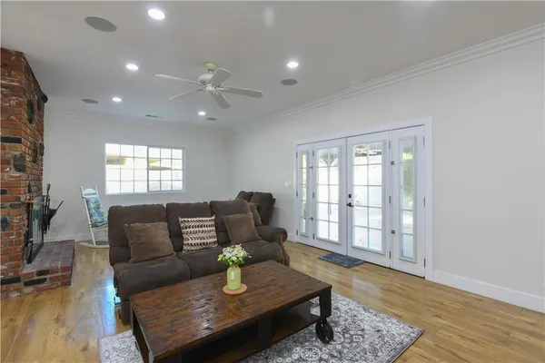 a living room with furniture and wooden floor
