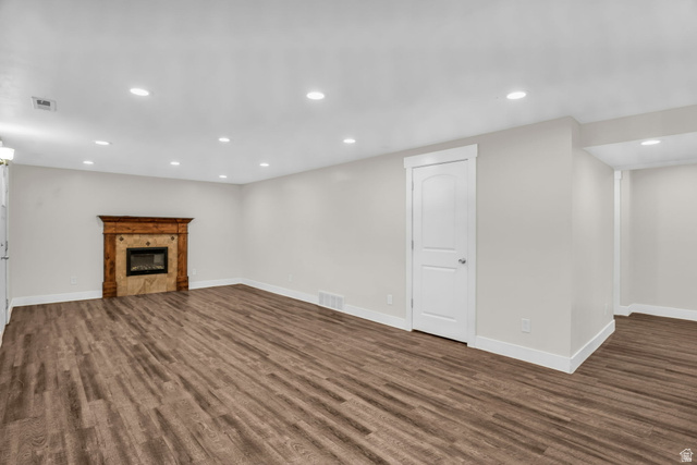 1836 West 800 North Mapleton, UT 84663 - Photo 23 of 38 Basement featuring recessed lighting, a tiled fireplace, and dark wood-style flooring