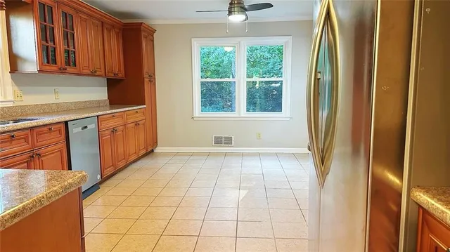 a view of a kitchen with kitchen island granite countertop a refrigerator and a sink