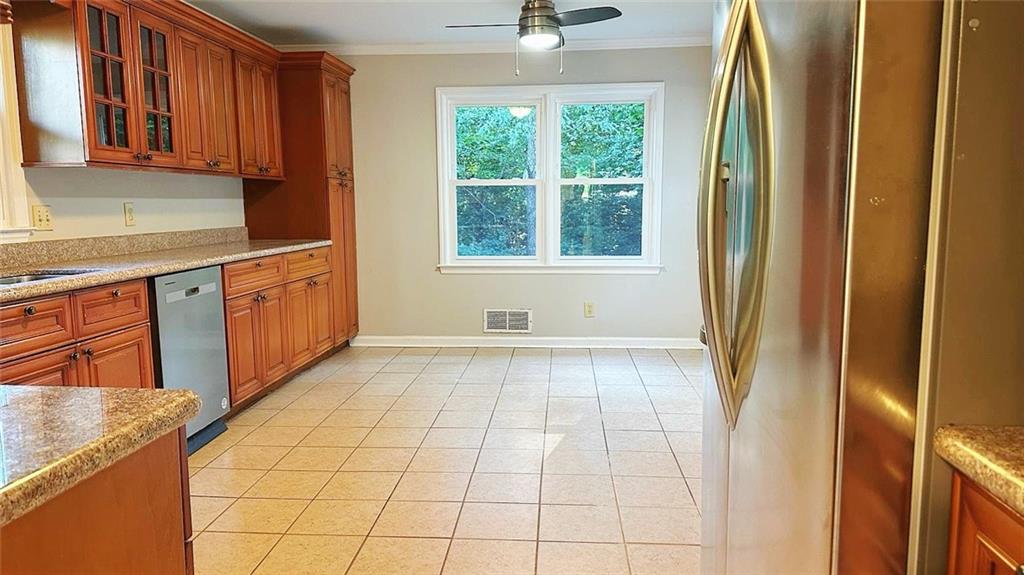 a view of a kitchen with kitchen island granite countertop a refrigerator and a sink