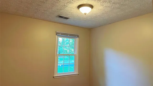 an empty room with a empty space and a window