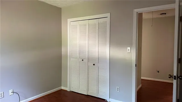 a view of an empty room with closet area