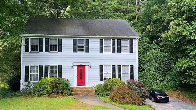 a aerial view of a house next to a yard