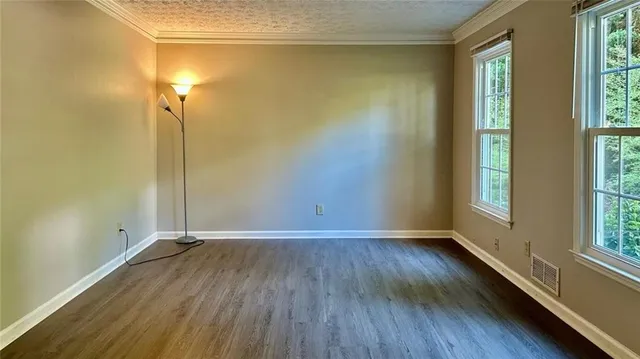 a view of room with window and wooden floor